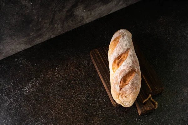 stock image Fresh homemade artisan loaf of baguette breads on rustic background with copy space. sourdough mini baguette breads.