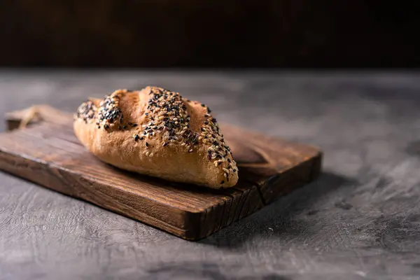 stock image Fresh homemade bread whole wheat baguette on napkin and abstract table. Sourdough bread