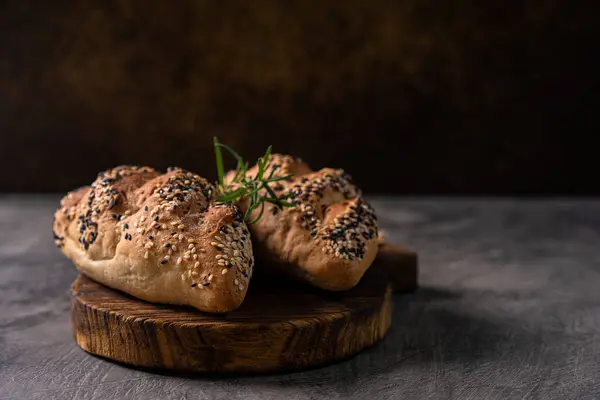 stock image Fresh homemade bread whole wheat baguette white milk and honey on rustic wooden board and abstract table. Sourdough bread