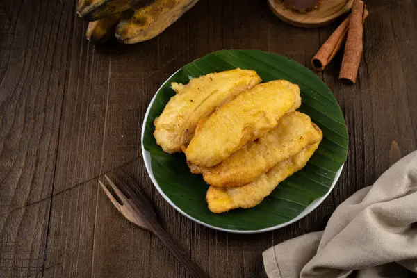 stock image Deep fried sweet crispy banana on white plate and banana leaf