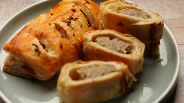 stock image A sausage roll is a savoury pastry meal, popular in current and former Commonwealth nations, consisting of sausage meat wrapped in puff pastry.