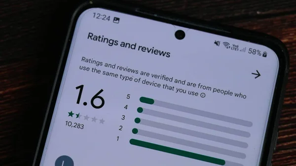 Androidスマートフォン上のGoogle Playストア上の1 6の最低評価とレビューアプリのスコア ロイヤリティフリーのストック画像