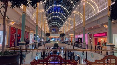 Trafford Centre shopping mall inside view with shops and restaurants in Trafford, Manchester England clipart