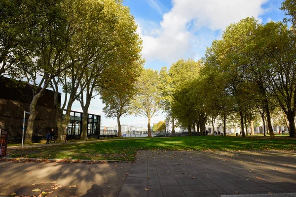 Concrete steps in the foreground of an emtpy autumnal park during fall