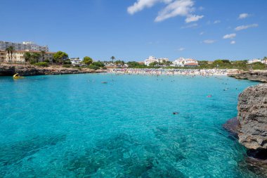 Popular tourist beach resort at high angle with clear water and sandy beach