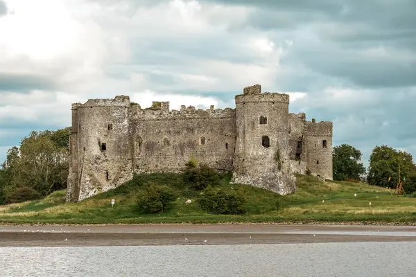 stock image Carew Castle in Wales exterior view over the nearby river is an historic point of interest for tourists to visit