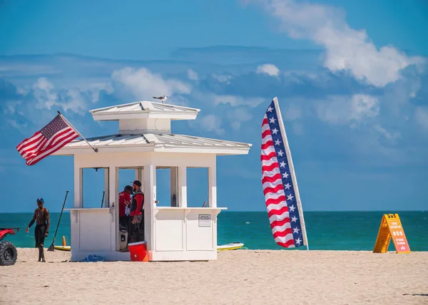 stock image White lifeguard station on South Beach with american flags.