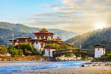 The famous Punakha Dzong with the wooden bridge clipart