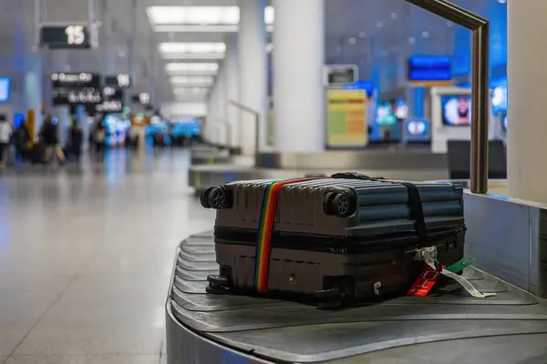 Suitcase or luggage arrivong on a conveyor belt in the airport