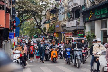 Vietnam Hanoi sokak sahnesi ve birçok scooterı var.