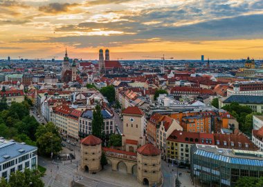 Isartor and Frauenkirche in warm summer evening light in Munich clipart