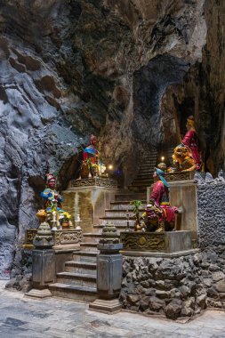 Steps with figurines in the marble mountain cave Hoa Nghiem in Danang city clipart