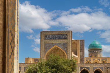 Bu resim, Özbekistan 'ın Buhara kentindeki tarihi Poi Kalon İslam kompleksinin kilit unsurları olan ikonik Kalyan Camii' ni gösteriyor..