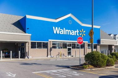 Walmart store exterior. Walmart is an American multinational corporation that runs large discount stores and is the worlds largest public corporation. clipart