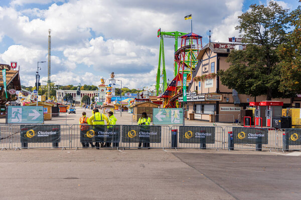 Oktoberfest grounds temporarily shut down after a bomb threat, with police presence and closed festival area.
