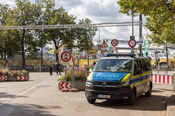 Oktoberfest grounds temporarily shut down after a bomb threat, with police presence and closed festival area.