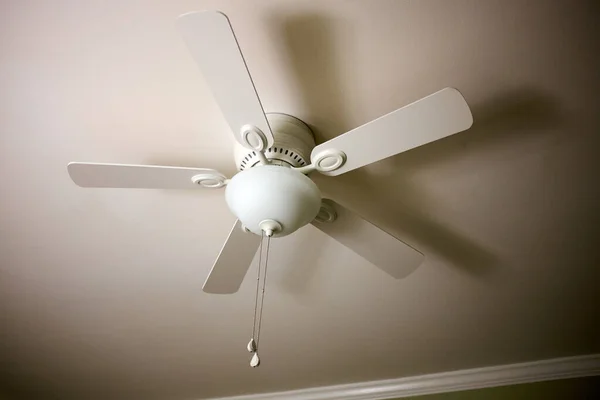 stock image Ceiling fan and light fitting combination on the ceiling of a residential building viewed from below