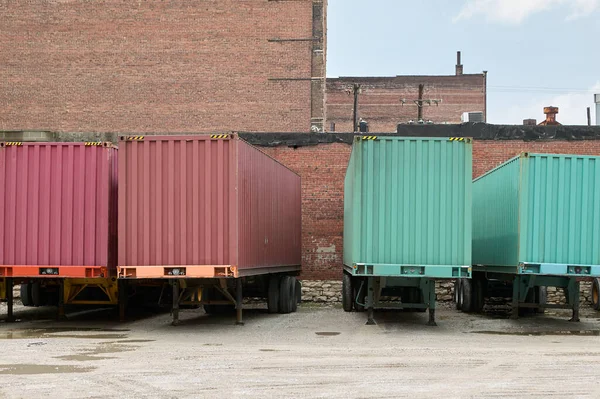 stock image Various heavy haulage truck transport trailers parked in line at a commercial depot.