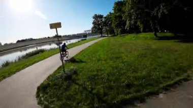 Opole, Polonya 'daki Opole Nehri boyunca sakin bir sabah bisikleti gezisi. Güneş parlıyor, kuşlar ötüyor ve su parlıyor. Güne başlamak için mükemmel bir yol..