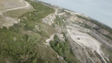 Bu nefes kesen hava görüntüsü sizi kayalık bir kanyonda, nefes kesici doğal güzelliğini gösteren bir yolculuğa çıkarıyor. Videoda hayranlık uyandıran uçurumlar, yemyeşil alanlar ve sakin bir nehir yer alıyor.