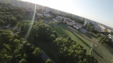 Bu yemyeşil yemyeşil ve huzurlu bir nehri olan bir parkın havadan görünüşü. Park bir banliyö bölgesinde yer almaktadır ve ağaçlar, çalılar ve çiçeklerle çevrilidir. Parkta akan bir nehir ekliyor.