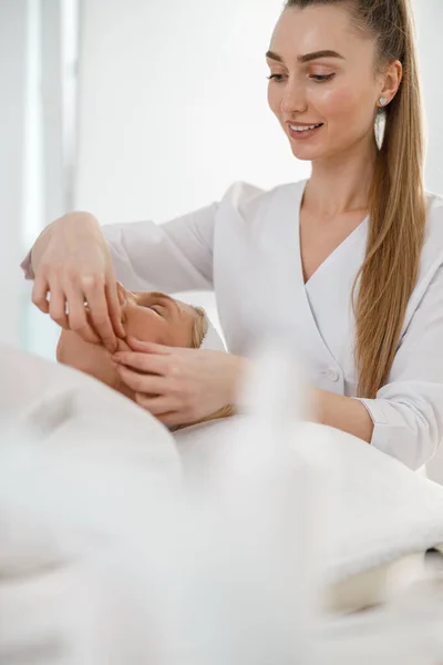 Happy Young Confident Female Beautician Doing Facial Massage Beautiful Blond — Stock Photo, Image