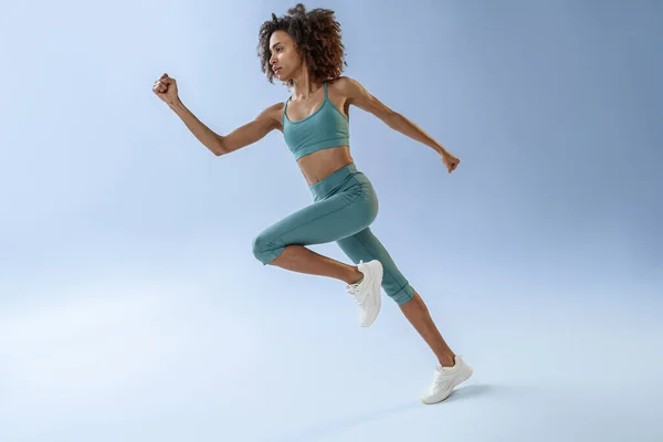 Athletic Active Woman Jumping Studio Background Dynamic Movement — Stockfoto