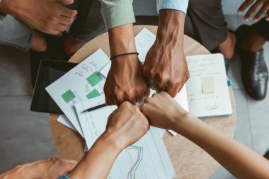 Group of coworkers stacked hands together as concept of corporate unity. High quality photo