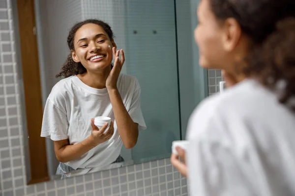 Smiling Woman Applying Wrinkle Cream Standing Mirror Home Bathroom High — Stock Photo, Image