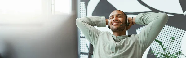 stock image Happy african businessman have a rest after working on computer in office. High quality photo