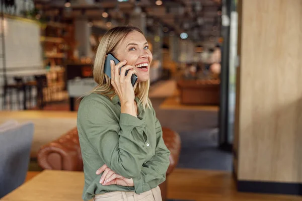 stock image Close up of smiling businesswoman is talking phone with client while standing in cafe