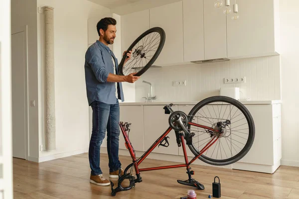 Handsome Smiling Man Casual Clothing Repairing Bicycle Itself Home High — Stock Photo, Image