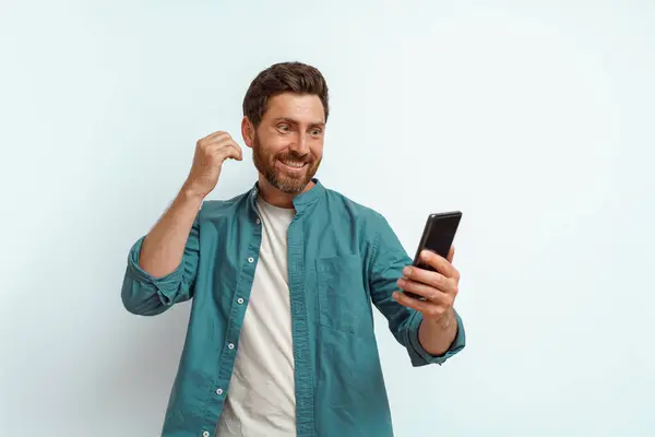 Man Showing Happy Gesture While Looking His Mobile Phone White — Stock Photo, Image