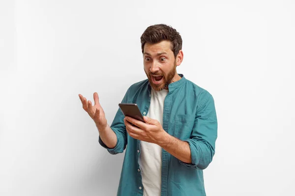 Man Showing Surprised Gesture While Looking Mobile Phone White Background — Stock Photo, Image