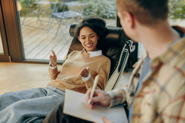 A young pretty woman is lying on a couch at a psychologists appointment in his office