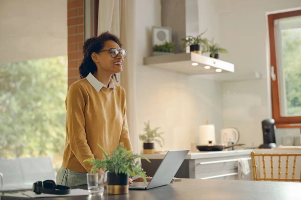 Attractive business woman working remotely on laptop from home. Distance work concept
