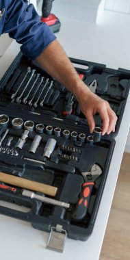 Mutfak zemininde duran açık alet çantalı erkek işçiye yakın çekim. Yüksek kalite fotoğraf