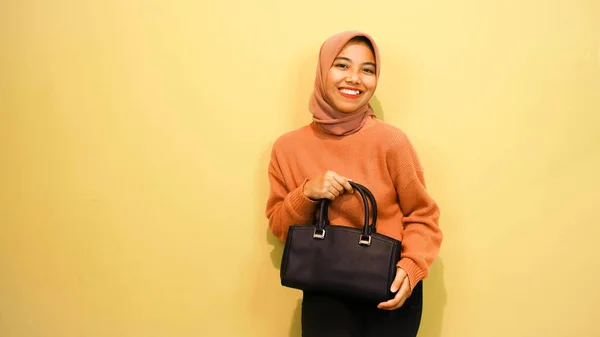 Happy Asian Girl Woman Holding Black Bag Standing Orange Background — Fotografia de Stock