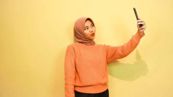 Young Beautiful Asian Woman Wearing Orange Sweater Use Smartphone Isolated — Stock Photo, Image