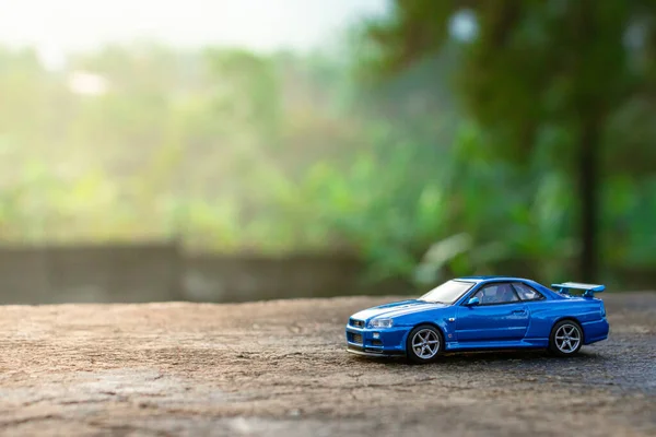 Bogor, Indonesia, December 31st, 2023 - Model car of Nissan Skyline R34 placed outdoor with sunshine effect. After some edits.