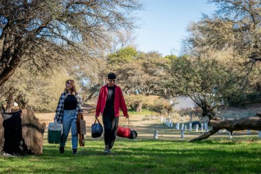 İki arkadaş kamp alanında yürüyor.