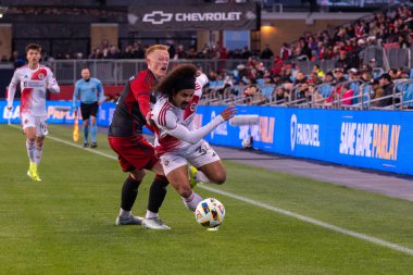 Toronto, ON, Kanada - 20 Nisan 2024: New England Revolution 'ın 34 numaralı savunucusu Toronto FC (Kanada) ile New England Revolution (ABD) arasında oynanan MLS Normal Sezonu karşılaşmasında topu sürüyor.