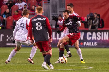 Toronto, ON, Canada - April 20, 2024: Federico Bernardeschi #10 forward of the Toronto FC dribbles with the ball during the MLS Regular Season match between Toronto FC (Canada) and New England Revolution (USA) at BMO Field clipart