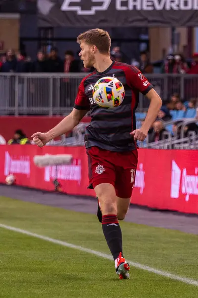 stock image Toronto, ON, Canada - April 20, 2024: Sigurd Rosted #17 defender of the Toronto FC moves with the ball during the MLS Regular Season match between Toronto FC (Canada) and New England Revolution (USA) at BMO Field