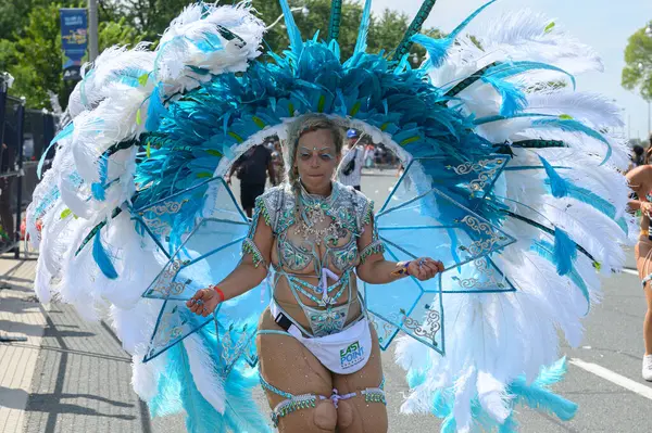 stock image Toronto, ON, Canada - August 5, 2023: parade participant dressed in glittering feathered parade costume for Toronto's Caribana Parade