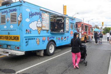 Toronto, ON, Canada - September 7, 2024:  Vendors present they product during the annual street festival Taste of The Kingsway 2024 clipart