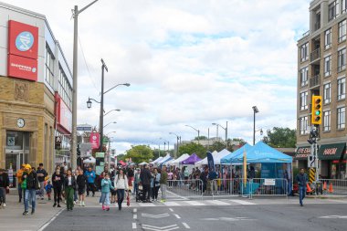 Toronto, ON, Canada - September 7, 2024: People outside enjoying the annual street festival Taste of The Kingsway 2024 clipart