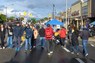 Toronto, ON, Canada - September 7, 2024: People outside enjoying the annual street festival Taste of The Kingsway 2024 clipart