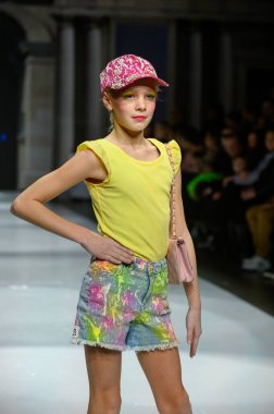 Toronto, ON, Kanada - 7 Aralık 2024: Toronto Çocuk Moda Haftası Moda Şovu sırasında bir manken Rain On Me (ROM) koleksiyonunda podyumda yürüyor.