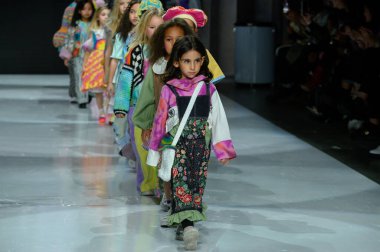 Toronto, ON, Kanada - 7 Aralık 2024: Toronto Çocuk Moda Haftası 'nda IANI koleksiyonunda bir model podyumda yürüyor.